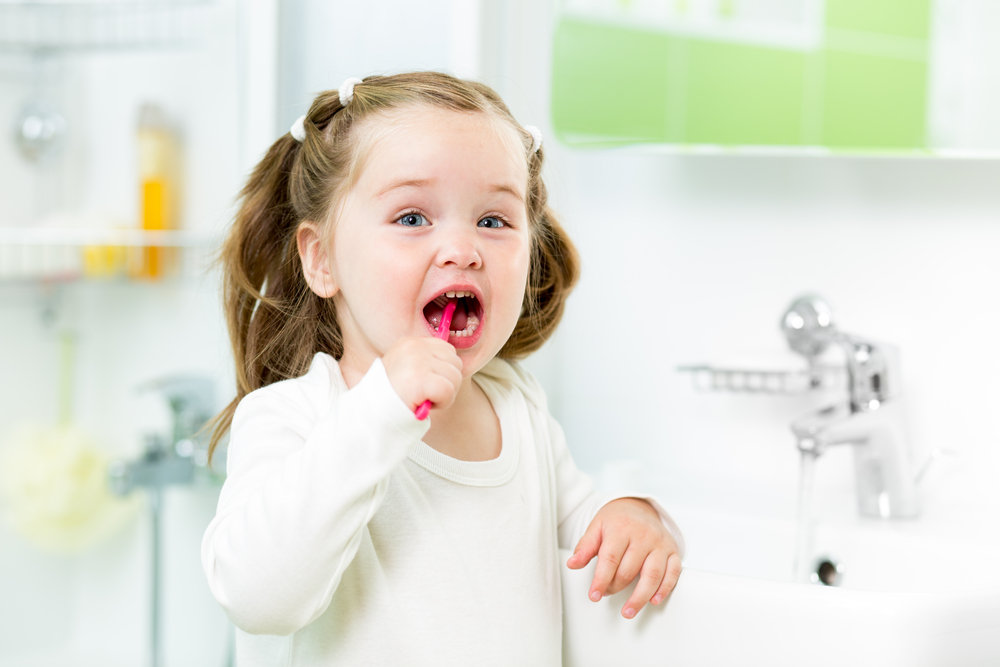 Small Girl Brushing Her Teeth (Tips for Creating Effective Hygiene Routines for Kids)