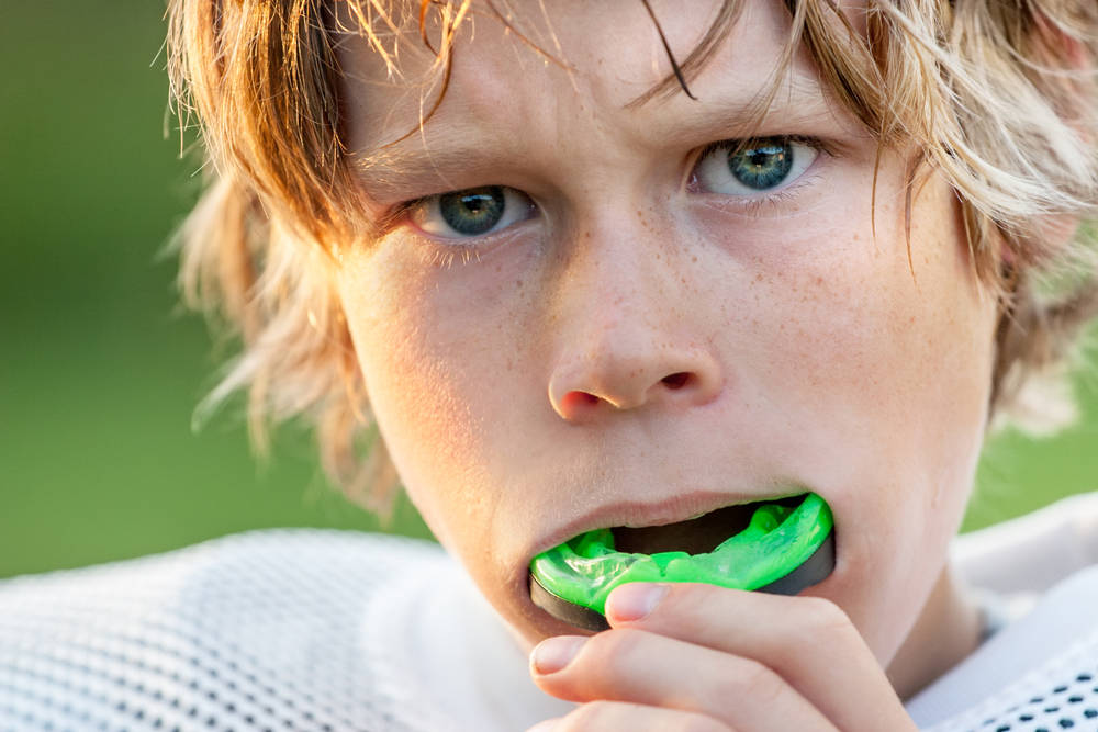 Boy with mouthguard - All About Sports Mouthguards